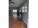 An open concept living room features vinyl flooring, a ceiling fan, and lots of natural light at 1922 Marvy Ave, Tampa, FL 33612