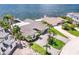 An elevated view of the property showcasing tropical landscaping and the adjacent waterfront and neighborhood at 2002 Carolina Ne Cir, St Petersburg, FL 33703