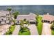 Scenic aerial view of a waterfront home, lush landscaping, and a private dock at 2002 Carolina Ne Cir, St Petersburg, FL 33703