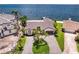 Waterfront home with a circular driveway and lush landscaping. Features a boat dock with direct access to the bay at 2002 Carolina Ne Cir, St Petersburg, FL 33703