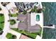 Waterfront property aerial view showcasing private dock, pool, and expansive property grounds with lush landscaping at 2002 Carolina Ne Cir, St Petersburg, FL 33703