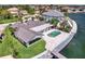 Aerial view of home and backyard featuring pool and waterfront access in a charming residential neighborhood at 2002 Carolina Ne Cir, St Petersburg, FL 33703