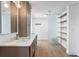 Modern bathroom features double vanity, marble countertop, wood floors, and open shelving at 2002 Carolina Ne Cir, St Petersburg, FL 33703