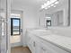 Bright bathroom boasts marble countertops, modern fixtures, and view to the water at 2002 Carolina Ne Cir, St Petersburg, FL 33703