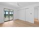 Bright bedroom with water views, features sliding glass doors and laminate floors at 2002 Carolina Ne Cir, St Petersburg, FL 33703