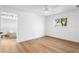 Bright bedroom features hardwood floors, a ceiling fan, and an ensuite bathroom at 2002 Carolina Ne Cir, St Petersburg, FL 33703
