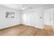 A bright and airy bedroom features hardwood floors, closet and view to bathroom at 2002 Carolina Ne Cir, St Petersburg, FL 33703
