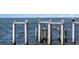 Dockside boat lift structure on a clear day, providing secure storage and easy water access at 2002 Carolina Ne Cir, St Petersburg, FL 33703