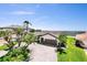 Exterior view of waterfront home with lush landscaping, private boat dock, and circular driveway at 2002 Carolina Ne Cir, St Petersburg, FL 33703