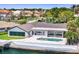 Waterfront home featuring a private pool and dock access to the waterway with lush landscaping for curb appeal at 2002 Carolina Ne Cir, St Petersburg, FL 33703