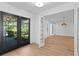 Elegant foyer with decorative glass doors leading to spacious living area and views of lush landscaping at 2002 Carolina Ne Cir, St Petersburg, FL 33703
