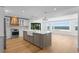 Open kitchen boasts a center island with marble countertops and stainless steel appliances at 2002 Carolina Ne Cir, St Petersburg, FL 33703