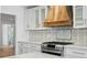 Updated kitchen with stainless steel appliances, custom range hood, and stylish tile backsplash at 2002 Carolina Ne Cir, St Petersburg, FL 33703