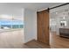 Light filled living room with ocean views, sliding barn door into ensuite bathroom at 2002 Carolina Ne Cir, St Petersburg, FL 33703