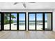 Bright, spacious living room with a view of the pool, with floor to ceiling windows at 2002 Carolina Ne Cir, St Petersburg, FL 33703