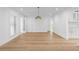 Bright living room with a statement light fixture and wood flooring at 2002 Carolina Ne Cir, St Petersburg, FL 33703
