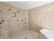 Luxurious shower with tan tiles, multiple shower heads, and built in seating at 2002 Carolina Ne Cir, St Petersburg, FL 33703