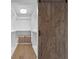 Spacious walk-in closet with custom shelving and a rustic barn door at 2002 Carolina Ne Cir, St Petersburg, FL 33703