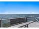 Relaxing waterfront view from the private dock, featuring a built-in bench, clear skies, and serene water at 2002 Carolina Ne Cir, St Petersburg, FL 33703