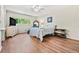 Inviting bedroom with hardwood floors, ceiling fan, and well-lit window at 2254 Norwegian Dr # 22, Clearwater, FL 33763