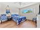 Comfortable bedroom with hardwood floors, ceiling fan, and blue accents at 2254 Norwegian Dr # 22, Clearwater, FL 33763