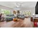 Bright living room with hardwood floors, ceiling fan, and multiple seating arrangements for relaxing at 2254 Norwegian Dr # 22, Clearwater, FL 33763
