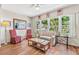 Sitting room featuring hardwood floors, matching chairs, and natural light from large windows at 2254 Norwegian Dr # 22, Clearwater, FL 33763
