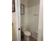 Compact half bathroom featuring neutral decor and a functional toilet at 2411 Willimette Dr, Wesley Chapel, FL 33543