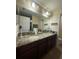 Bathroom featuring a double vanity, granite countertop, and a large mirror at 2411 Willimette Dr, Wesley Chapel, FL 33543
