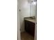 Cozy half bathroom with a granite countertop and woven rug at 2411 Willimette Dr, Wesley Chapel, FL 33543