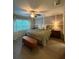 Inviting bedroom featuring a ceiling fan, window with curtains, and a comfortable bed at 2411 Willimette Dr, Wesley Chapel, FL 33543
