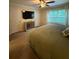 Spacious bedroom with a ceiling fan, large bed, and window with natural light at 2411 Willimette Dr, Wesley Chapel, FL 33543