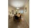 Dining area with a wooden table, upholstered chairs, and view of the kitchen at 2411 Willimette Dr, Wesley Chapel, FL 33543