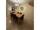 Dining room features a modern chandelier, tile flooring, and a view of the kitchen area at 2411 Willimette Dr, Wesley Chapel, FL 33543