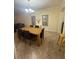 Formal dining room with wooden table, upholstered chairs, stylish chandelier, and modern decor at 2411 Willimette Dr, Wesley Chapel, FL 33543