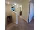 Upstairs hallway featuring carpet, multiple doors, and access to bathroom at 2411 Willimette Dr, Wesley Chapel, FL 33543