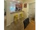 Kitchen area with counter seating, tiled floor, and view to the half bath at 2411 Willimette Dr, Wesley Chapel, FL 33543