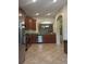 Spacious kitchen overlooking the living area, stainless steel appliances, tile floors at 2411 Willimette Dr, Wesley Chapel, FL 33543