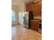 Bright kitchen with modern stainless steel refrigerator and ample cabinet space at 2411 Willimette Dr, Wesley Chapel, FL 33543