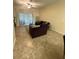 Cozy living room featuring plush seating, neutral colors, and sliding glass doors to the outside at 2411 Willimette Dr, Wesley Chapel, FL 33543