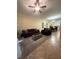 Open-concept living room with tile flooring, comfortable seating, and a view of the dining area at 2411 Willimette Dr, Wesley Chapel, FL 33543