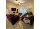 Living room featuring comfortable seating, a ceiling fan, and sliding doors to the outside at 2411 Willimette Dr, Wesley Chapel, FL 33543