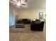 Inviting living room with comfortable seating, a ceiling fan, and sliding doors to the outside at 2411 Willimette Dr, Wesley Chapel, FL 33543