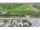Aerial view showcasing the neighborhood's proximity to a golf course and waterway at 2452 Bayshore Blvd, Dunedin, FL 34698