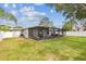 View of a spacious backyard with a screened-in porch, great for relaxation at 2452 Bayshore Blvd, Dunedin, FL 34698
