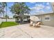 Relaxing backyard patio with a screened-in porch and stylish outdoor furniture at 2452 Bayshore Blvd, Dunedin, FL 34698