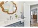 Charming bathroom with designer mirror, chrome fixtures, and stylish gray vanity at 2452 Bayshore Blvd, Dunedin, FL 34698