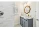 Stylish bathroom features a modern vanity with brushed hardware, shower, and designer mirror at 2452 Bayshore Blvd, Dunedin, FL 34698