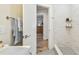 Tastefully designed walk-in shower with decoratively tiled floors and modern, chrome fixtures at 2452 Bayshore Blvd, Dunedin, FL 34698