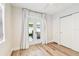 Bedroom featuring wood-look floors and double doors leading to a patio with additional seating at 2452 Bayshore Blvd, Dunedin, FL 34698